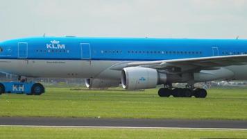AMSTERDAM, THE NETHERLANDS JULY 26, 2017 - KLM Airbus 330 PH AOD being towed by a tractor to service. Schiphol Arport, Amsterdam, Netherlands video