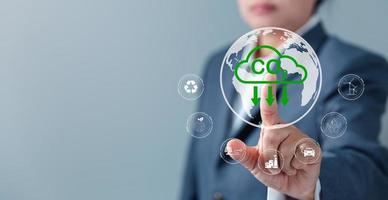 Sustainable development and innovation green business concept. Businesswoman working virtual globe modern computer to reduce CO2 emissions carbon footprint climate change to limit global warming. photo