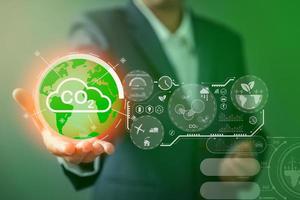 Sustainable development and innovation green business concept. Businesswoman working virtual globe modern computer to reduce CO2 emissions carbon footprint climate change to limit global warming. photo
