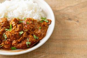 chicken tikka masala with rice on plate photo