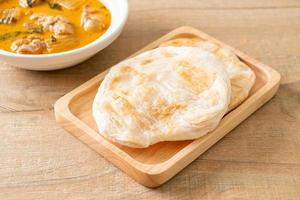 Chicken curry soup with roti photo