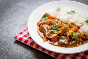 Japanese curry rice with sliced pork, carrot and onions photo