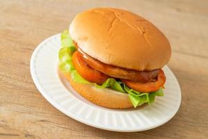 chicken burger with sauce on plate photo