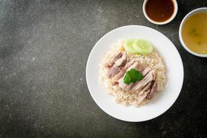 Hainanese Chicken Rice or steamed rice with chicken photo