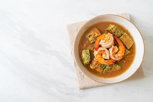 Sour soup made of Tamarind Paste with Shrimps and Vegetable Omelet photo
