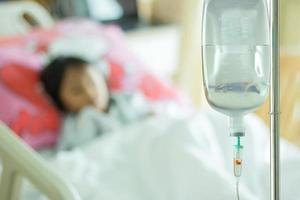 saline solution and children patient on bed at hospital room photo