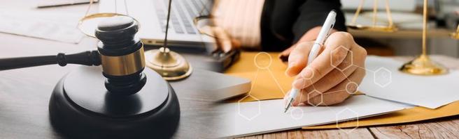 Business and lawyers discussing contract papers with brass scale on desk in office. Law, legal services, advice, justice and law concept picture with film grain effect photo