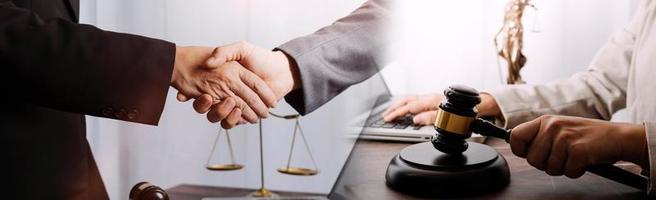 Business and lawyers discussing contract papers with brass scale on desk in office. Law, legal services, advice, justice and law concept picture with film grain effect photo