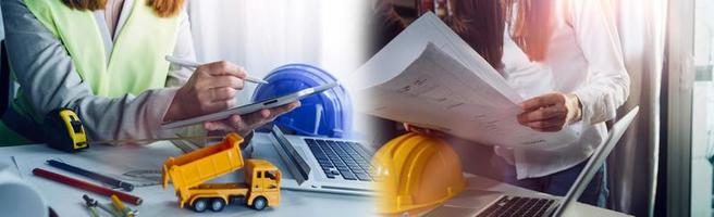 Two colleagues discussing data working and tablet, laptop with on on architectural project at construction site at desk in office photo