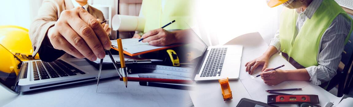 Two colleagues discussing data working and tablet, laptop with on on architectural project at construction site at desk in office photo