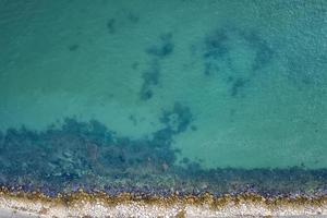 Top view aerial photo from flying drone of the beautiful transparent sea and coastline for your advertising text message or promotional content. website background.