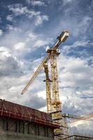Day view of the construction site with cranes and building. Vertical view photo