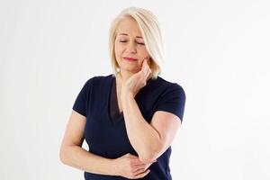 woman with toothache, Attractive middle aged woman pressing her bruised cheek with a painful expression as if she's having a terrible tooth ache. Female tooth pain cocncept, medicine dentistry concept photo