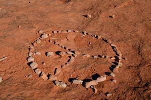 Peace Sign Created from Rocks on Red Dirt photo