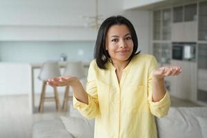 Puzzled woman feels perplexity shrugging shoulders, doesn't know answer. Dilemma, difficult choice photo