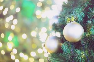Closeup of bauble colorful variety hanging from a decorated christmas tree on blurred of lights with decorated tree, sparkling and bokeh background. copy space for your text. Christmas Tree Decoration photo