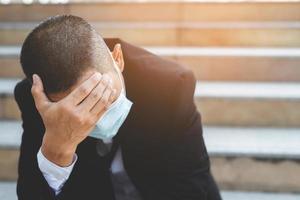 Businessman sitting stressed. Business bankrupt from Covid-19. photo