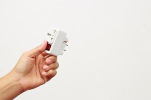 An extension socket is a device that consists of several components, such as a power cord, an electrical socket, an outlet, a power strip, and an electrical switch. photo