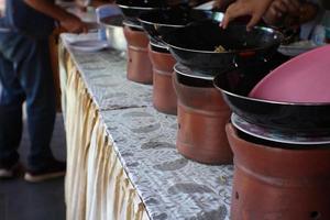 a place to serve dishes made of earth and a wok made of iron. photo