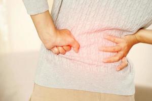 Lower back pain is usually caused by a muscle injury. broken pillow photo