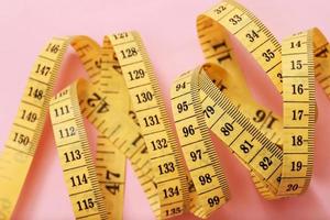 tape measure for obese people on a pink background soft focus photo