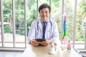 doctor with stethoscope using smartphone in office. photo