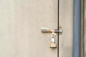 closed door with padlock. metal door texture background with space photo