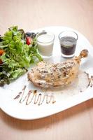 Roasted Chicken on wooden background photo