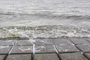 Dyke dike mudflat waves landscape North Sea coast Nordenham Germany. photo