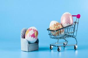 The idea of home delivery of purchases for Easter, on a blue background, the concept of online shopping, e-commerce, sales photo