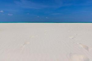 Amazing nature of tropical summer beach. White sandy beach, lagoon sea water against blue sky with white clouds. Copy space, summer vacation concept, tranquil relaxing turquoise ocean, freedom travel photo