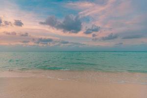 Closeup sea sand beach. Panoramic beach landscape. Inspire tropical beach seascape horizon. Orange and golden sunset sky calmness tranquil relaxing sunlight summer mood. Vacation travel holiday banner photo