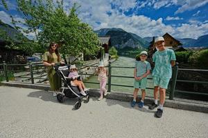 Mother with four kids on the bridge at old town Hallstatt,Austria. photo