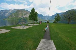 Boy swinging on rope at playground Hallstatt, Austria. photo