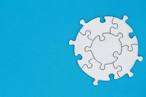 White jigsaw pieces on a blue background, Copy space, Concept image of unfinished task.  missing jigsaw puzzle pieces and business concept with a puzzle piece missing. photo