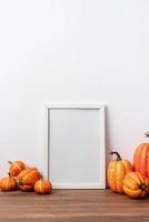 Art photo frame mockup with scarfs and autumn leaves, white background