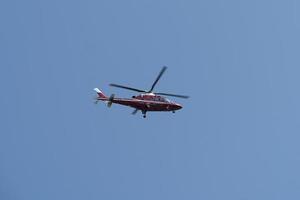 Helicopter on the blue sky photo