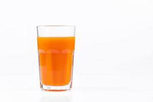 Pumpkin juice in transparent glass isolated on white background. Vegetable vegetarian drink. Healthy food and diet. photo