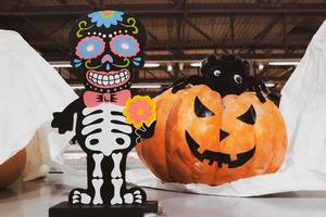 Decorations for Halloween and Day of the Dead in Mexico. Skeleton and fresh pumpkins. Scary decor to celebrate Dia Los Muertos. photo