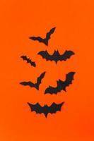 Halloween concept. Festive decorations. Bats on orange background. photo