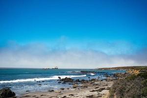 Pacific ocean beach with rocks photo