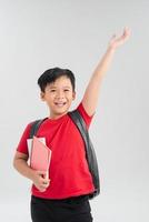 Back to school. Happy exciting child boy ready to study with backpack isolated on white. Kid win and jump with hand up photo