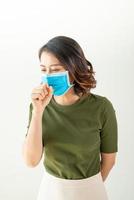 Woman wearing mask to avoid virus and feeling sick photo