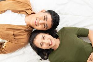 Overhead close up of young couple lying in bed together photo