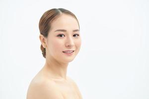 Close up young beautiful Asian woman face over white background. photo