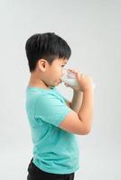 kid drinking milk on white background photo