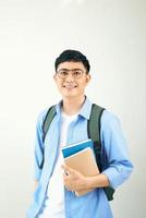 Handsome young student smiling and holding a notebook, isolated on white background photo