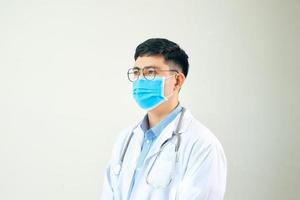 Handsome doctor portrait with a white coat, face mask photo