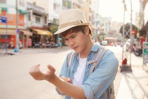 Overwhelmed adult man scratching itchy arm standing in the street photo