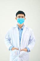 Young asian man in medical field, wearing a white coat and face mask, photo